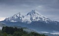 Snow covered mountain peaks of Watzmann at Berchtesgaden with clouds with morning fog, Bavaria Royalty Free Stock Photo