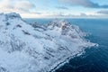 Snow covered mountain range on coastline in winter, Norway. Senja panoramic aerial view, Troms county, Fjordgard