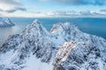 Snow covered mountain range on coastline in winter, Norway. Senja panoramic aerial view, Troms county, Fjordgard