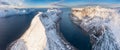 Snow covered mountain range on coastline in winter, Norway. Senja panoramic aerial view, Troms county, Fjordgard