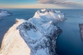 Snow covered mountain range on coastline in winter, Norway. Senja panoramic aerial view, Troms county, Fjordgard