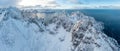 Snow covered mountain range on coastline in winter, Norway. Senja panoramic aerial view, Troms county, Fjordgard