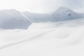 snow-covered mountain range with a snow-covered field on which there are traces of skiers and snowboarders, freeride Royalty Free Stock Photo