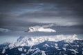 Snow covered mountain summit Hochtor in winter with some clouds