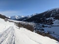 Snow covered mountain village of munster inf valais, the first rays of sunshine are shining over the mountains Royalty Free Stock Photo