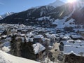 Snow covered mountain village of munster inf valais, the first rays of sunshine are shining over the mountains Royalty Free Stock Photo