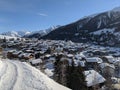 Snow covered mountain village of munster inf valais, the first rays of sunshine are shining over the mountains Royalty Free Stock Photo