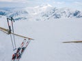 Snow covered mountains and alpine skis on a foreground