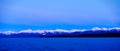 Snow covered mountains and blue ocean Royalty Free Stock Photo