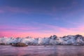 Snow covered mountains and colorful sky reflected in water Royalty Free Stock Photo