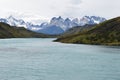 Snow covered mountains with the light blue ocean in front in Torres del Paine National Park in Chile, Patagonia Royalty Free Stock Photo