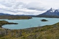 Snow covered mountains with the light blue ocean in front in Torres del Paine National Park in Chile, Patagonia Royalty Free Stock Photo