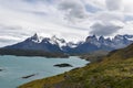 Snow covered mountains with the light blue ocean in front in Torres del Paine National Park in Chile, Patagonia Royalty Free Stock Photo
