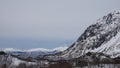 Snow covered mountains and fjord near Austerstraumen bru in winter in Norway