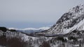 Snow covered mountains and fjord near Austerstraumen bru in winter in Norway