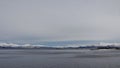 Snow covered mountains and ocean from Hinnoya near Holdoya in winter in Norway