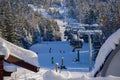 Snow covered mountains panorama - snowboarders and skiers ride on slopes and ski lifts. Ski resort in Whistler, Canada Royalty Free Stock Photo