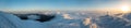 Snow covered mountains panorama. Sunrise. Frosted cross on top is seen on photo