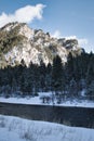 Snow covered mountains by river in winter in Montana Royalty Free Stock Photo