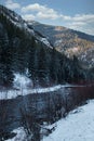 Snow covered mountains by river in winter in Montana Royalty Free Stock Photo