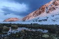 Snow-covered mountains in sunset glow