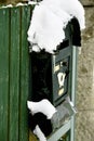 Snow covered old mailbox on wooden door Royalty Free Stock Photo