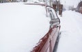 Snow-covered old red car during the snowfall Royalty Free Stock Photo