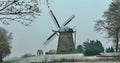 A snow covered old windmill on a hill. Location: Uelsen, Germany Royalty Free Stock Photo