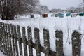 Snow covered old wooden fence with moss in the park Royalty Free Stock Photo