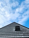 Snow covered open roof window in velux style with black roof tiles