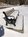 snow covered park bench beside walkway, at Dean Park Shrewsbury MA Royalty Free Stock Photo