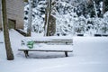 Snow-covered park bench during winter