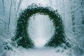 A snow covered path with a large archway in the middle Royalty Free Stock Photo