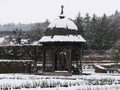 Snow-covered pavilion in the park of the baroque castle Royalty Free Stock Photo