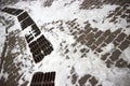 snow-covered paving stone sidewalk and drainage system hatches in the park