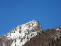 Snow covered peak of the highest mountain with a cross on top Royalty Free Stock Photo