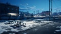 Snow-covered picnic area illuminated by lights in an urban setting during winter evening Royalty Free Stock Photo