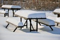 Snow covered picnic tables Royalty Free Stock Photo