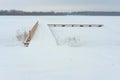 Snow covered pier over a frozen lake - winter landscape Royalty Free Stock Photo