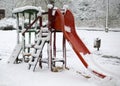 Snow covered playground in city