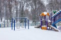 Snow covered playground in the city park on a winter day