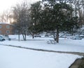 Snow covered playground and parking lot of apartment