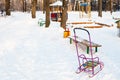 Snow-covered playground in urban park in winter