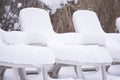 Snow covered pool deck chairs Royalty Free Stock Photo