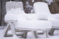 Snow covered pool deck chairs Royalty Free Stock Photo
