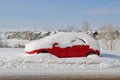 Snow covered red car