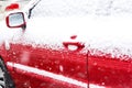 Snow-covered red car in winter