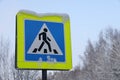 Snow covered road pedestrian sign. It was snowing in the city. Close up Royalty Free Stock Photo