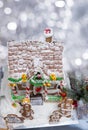 Snow-covered roof of homemade gingerbread house with protruding