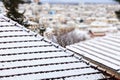 Snow-covered rooftops. Winter, time for vacation at a town in frost. Blur backdrop, close up, detail